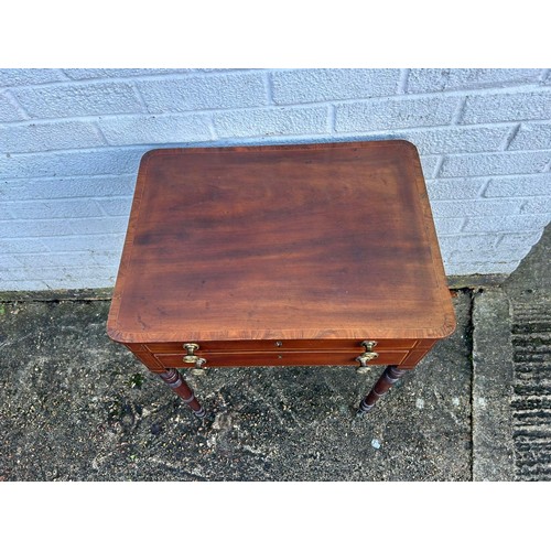 392A - A two drawer side table, with crossbanded top over ring turned legs and casters -