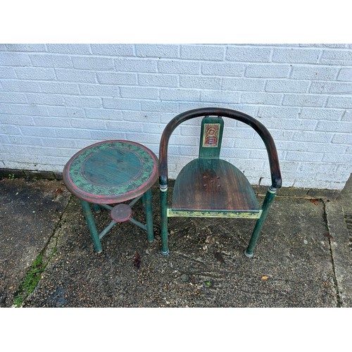 256 - A carved and stained table and chair, from Singapore, carved with scrolling leaf and flower detail -