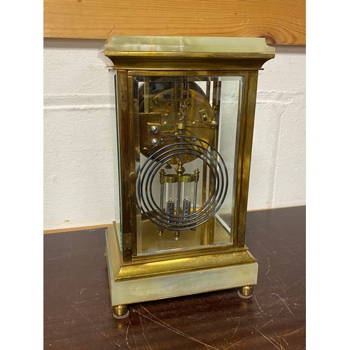 257 - A brass and onyx mounted mantel clock, the dial painted with floral swags and arabic markers -