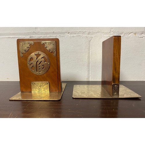 167 - A pair of brass mounted bookends each with bat, dragon and foliage engraving -