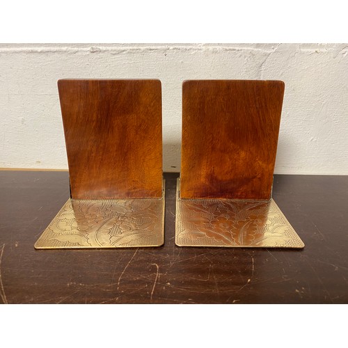 167 - A pair of brass mounted bookends each with bat, dragon and foliage engraving -