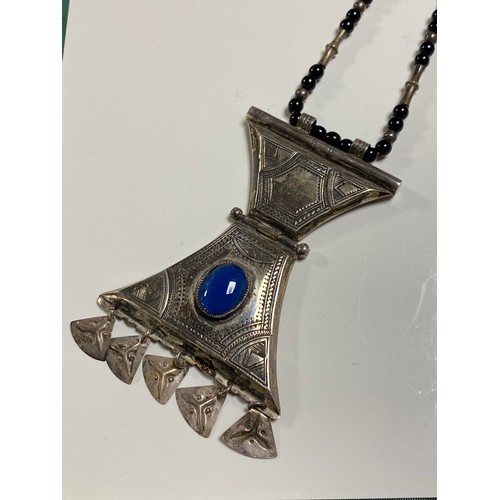 6 - A white metal and blue hardstone pendant on chain, possibly Tuareg -