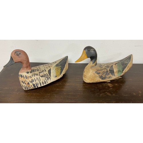 61 - A matched pair of antique carved and painted decoy ducks -