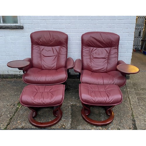 291 - A pair of Ekornes Stressless burgundy leather reclining chairs with footstools and trays -