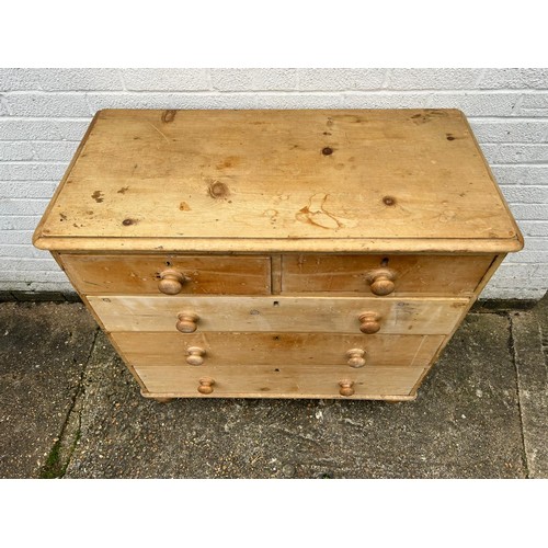 296 - A stripped pine chest, fitted with two short and three long drawers -