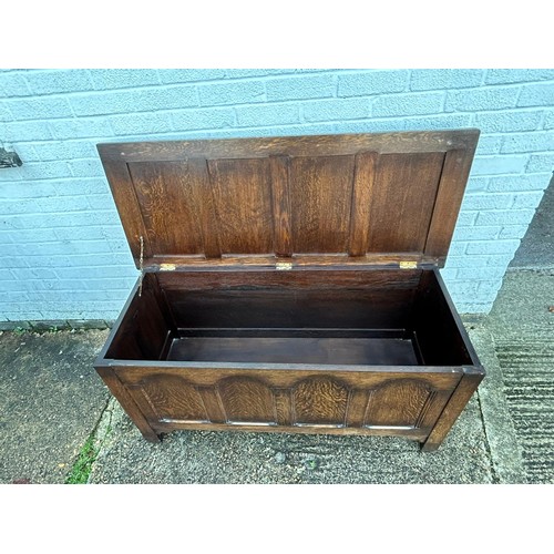 305 - An oak coffer, with panelled top and sides -