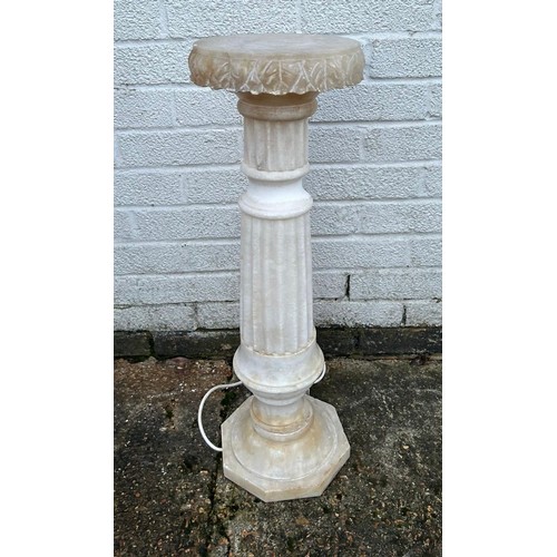 306 - An internally lit carved alabaster decorative stand -