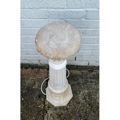 306 - An internally lit carved alabaster decorative stand -