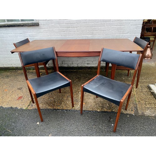 312 - A mid-century modern extending dining table, with four dining chairs -