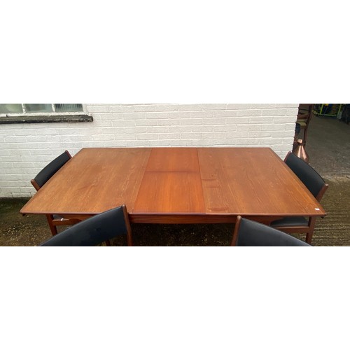 312 - A mid-century modern extending dining table, with four dining chairs -