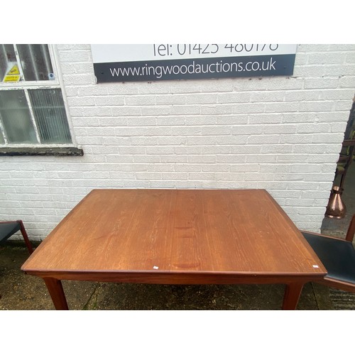 312 - A mid-century modern extending dining table, with four dining chairs -