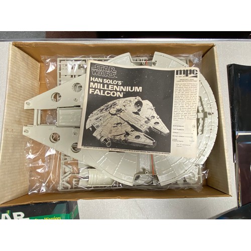 202 - A vintage MPC Star Wars Millennium Falcon kit together with Star Wars, Star Warriors role play game,... 