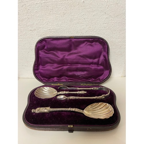 38 - A Victorian silver spoon and tongs set, London 1874, each piece with figural details, together with ... 