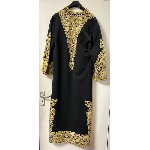 218 - A 1970s Iranian dress, worked in a gold thread on black -