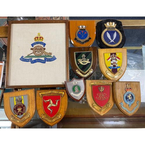 233 - Militaria: A collection of ensigns, flags and wall plaques -