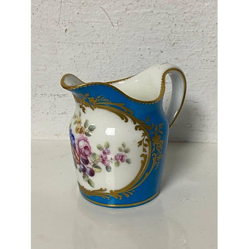 137 - A 19th Century Sevres jug, painted with a panel of flowers on a powder blue ground -