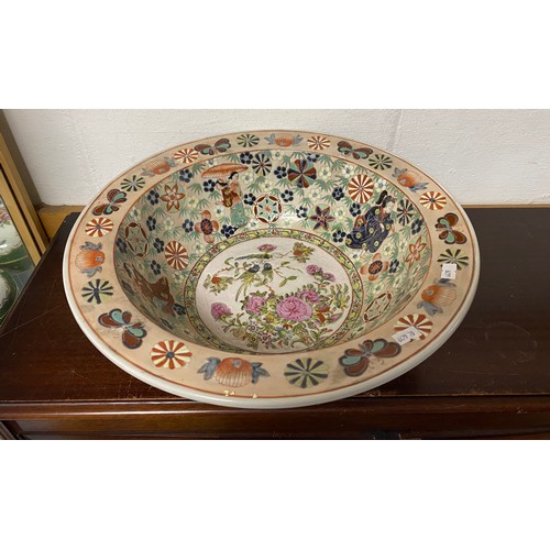 147 - A large basin/bowl, decorated with figures, flowers and birds -