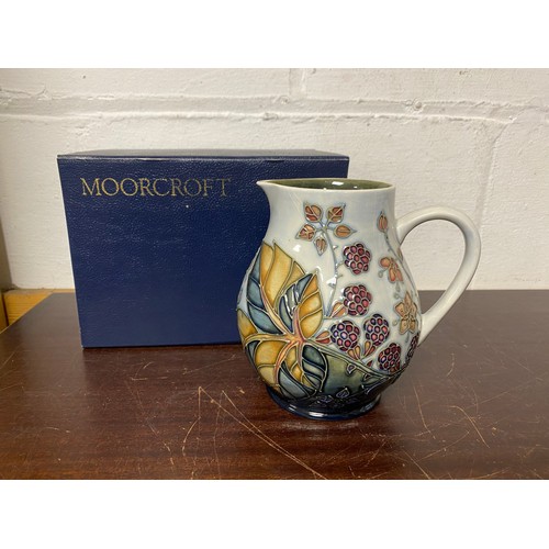 152 - A modern Moorcroft jug, in the 'Bramble' pattern -