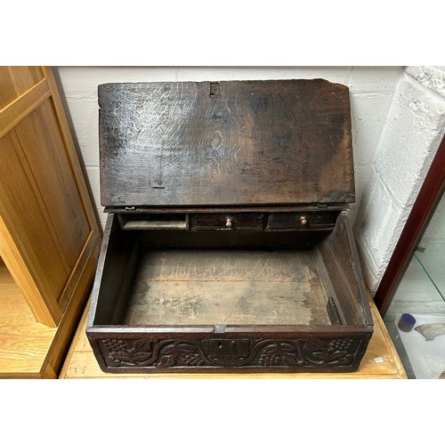 350 - An oak Bible box, with sloping front, carved with EB 1740, enclosing drawers over a carved fruiting ... 