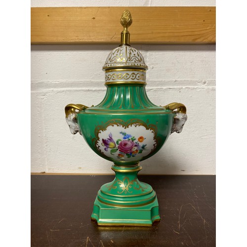 A Dresden porcelain lamp base, moulded with animal heads and painted with panels and flowers on a green ground, with gilt highlights -