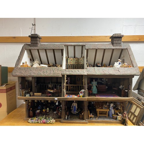 248 - A Robert Stubbs 'Radnor Hall' dolls house, designed as a three storey Tudor building, with eight lif... 