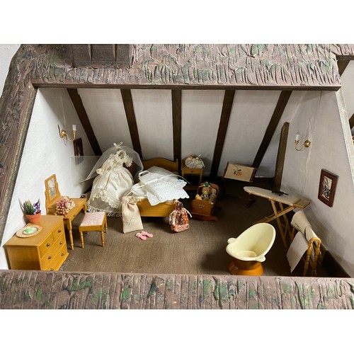 248 - A Robert Stubbs 'Radnor Hall' dolls house, designed as a three storey Tudor building, with eight lif... 