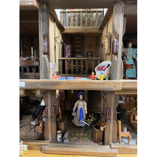 248 - A Robert Stubbs 'Radnor Hall' dolls house, designed as a three storey Tudor building, with eight lif... 