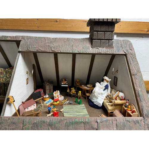 248 - A Robert Stubbs 'Radnor Hall' dolls house, designed as a three storey Tudor building, with eight lif... 