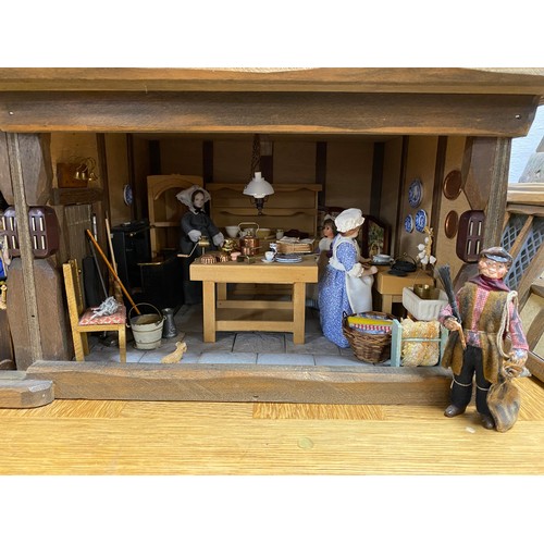 248 - A Robert Stubbs 'Radnor Hall' dolls house, designed as a three storey Tudor building, with eight lif... 
