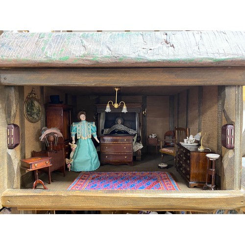248 - A Robert Stubbs 'Radnor Hall' dolls house, designed as a three storey Tudor building, with eight lif... 