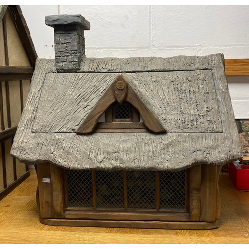 247 - A Robert Stubbs Tudor Dolls House, designed as a two storey building, with hat shop fittings and acc... 