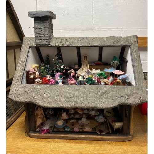247 - A Robert Stubbs Tudor Dolls House, designed as a two storey building, with hat shop fittings and acc... 