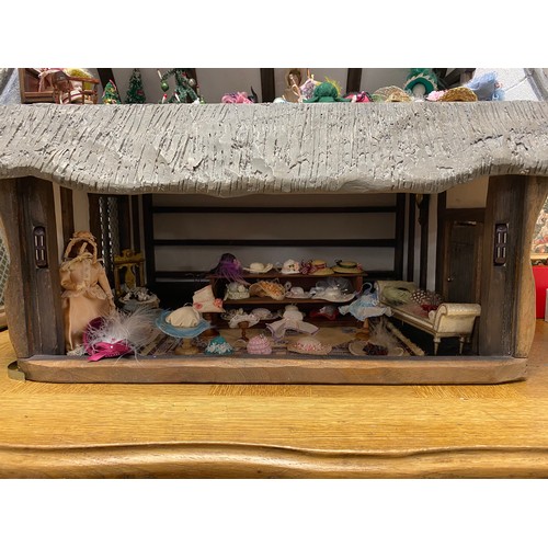 247 - A Robert Stubbs Tudor Dolls House, designed as a two storey building, with hat shop fittings and acc... 