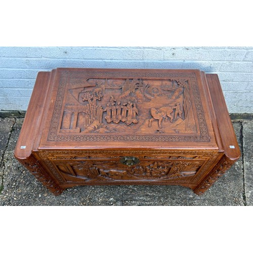 319 - A 20th Century Chinese carved blanket chest, typically carved with figures and animals  -