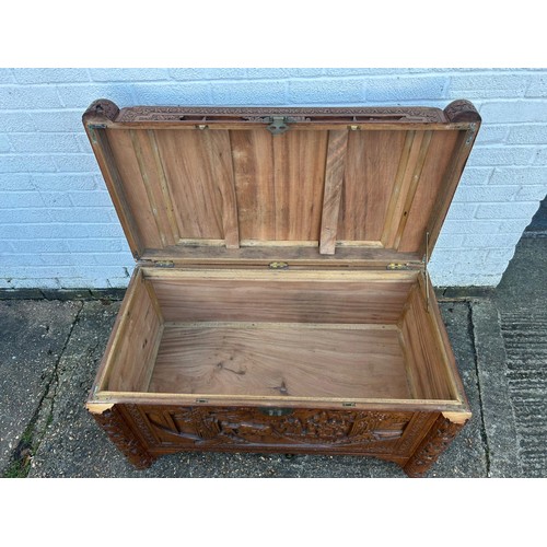 319 - A 20th Century Chinese carved blanket chest, typically carved with figures and animals  -