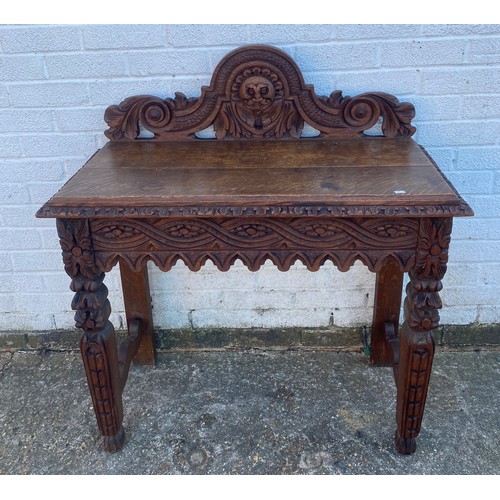 An carved oak side table  -