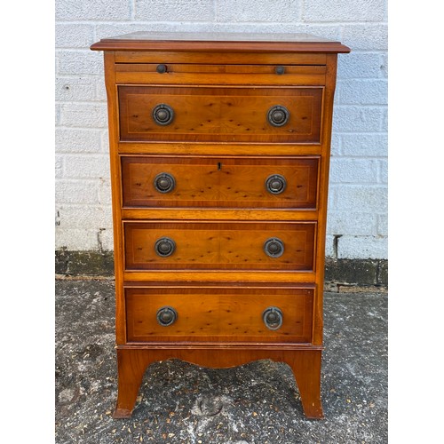 A reproduction yew finish bedside chest, with brushing slide over four drawers -