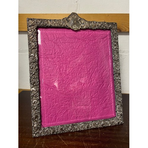 A large Edwardian silver photograph frame, Birmingham 1903, decorated with scrolls, foliage and flower head decoration (glass chipped to corner) -