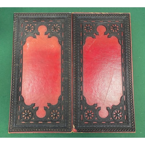 257 - A folding leather chess board the exterior applied with raised decoration -