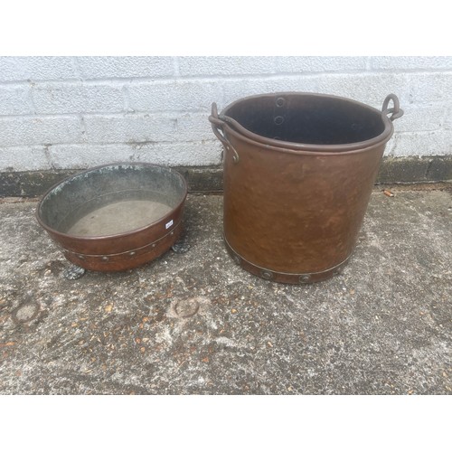 A copper log bin together with a brass pan -
