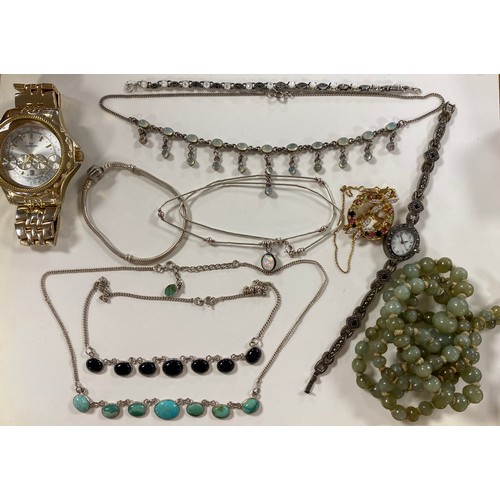 28 - A silver charm bracelet, brooches, cufflinks, and other jewellery items -