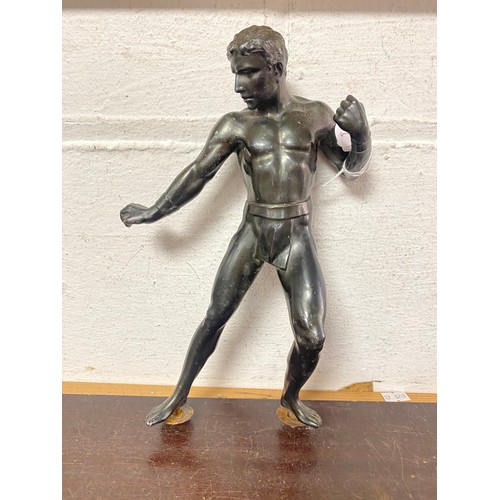 A bronze of a classical style wrestler, lacking base -