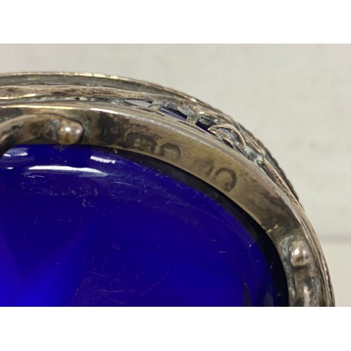35 - A Georgian silver open salt, marks rubbed, with blue glass liner, neo-classical swags and claw and b... 