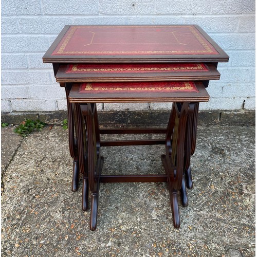 A reproduction nest of three tables, on lyre end supports -