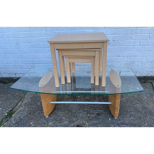 A contemporary glass topped coffee table and a nest of three tables -