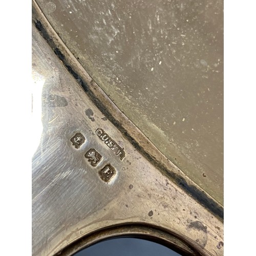 54 - A George V silver mounted hand mirror, Birmingham 1929, together with two associated silver mounted ... 