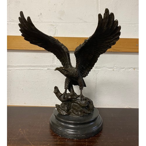 182 - A bronze model of an eagle, with wings outstretched, on circular base -
