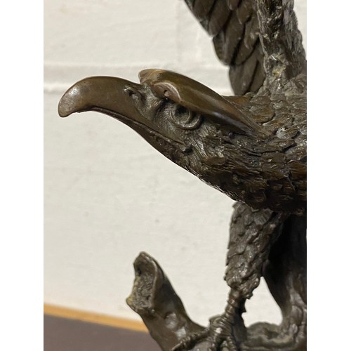 182 - A bronze model of an eagle, with wings outstretched, on circular base -