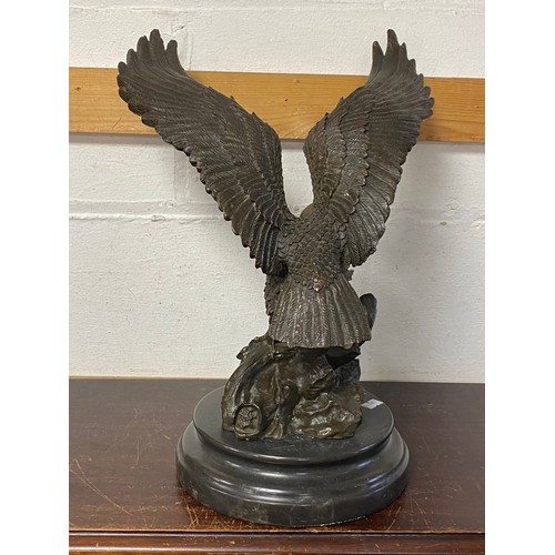 182 - A bronze model of an eagle, with wings outstretched, on circular base -