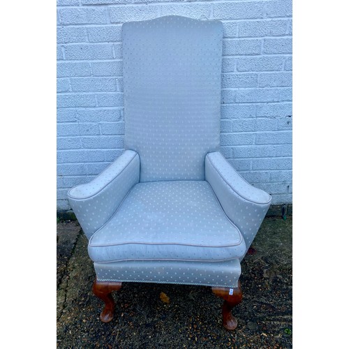 470 - An 18th Century style armchair, with high back, outswept arms, and short cabriole legs -